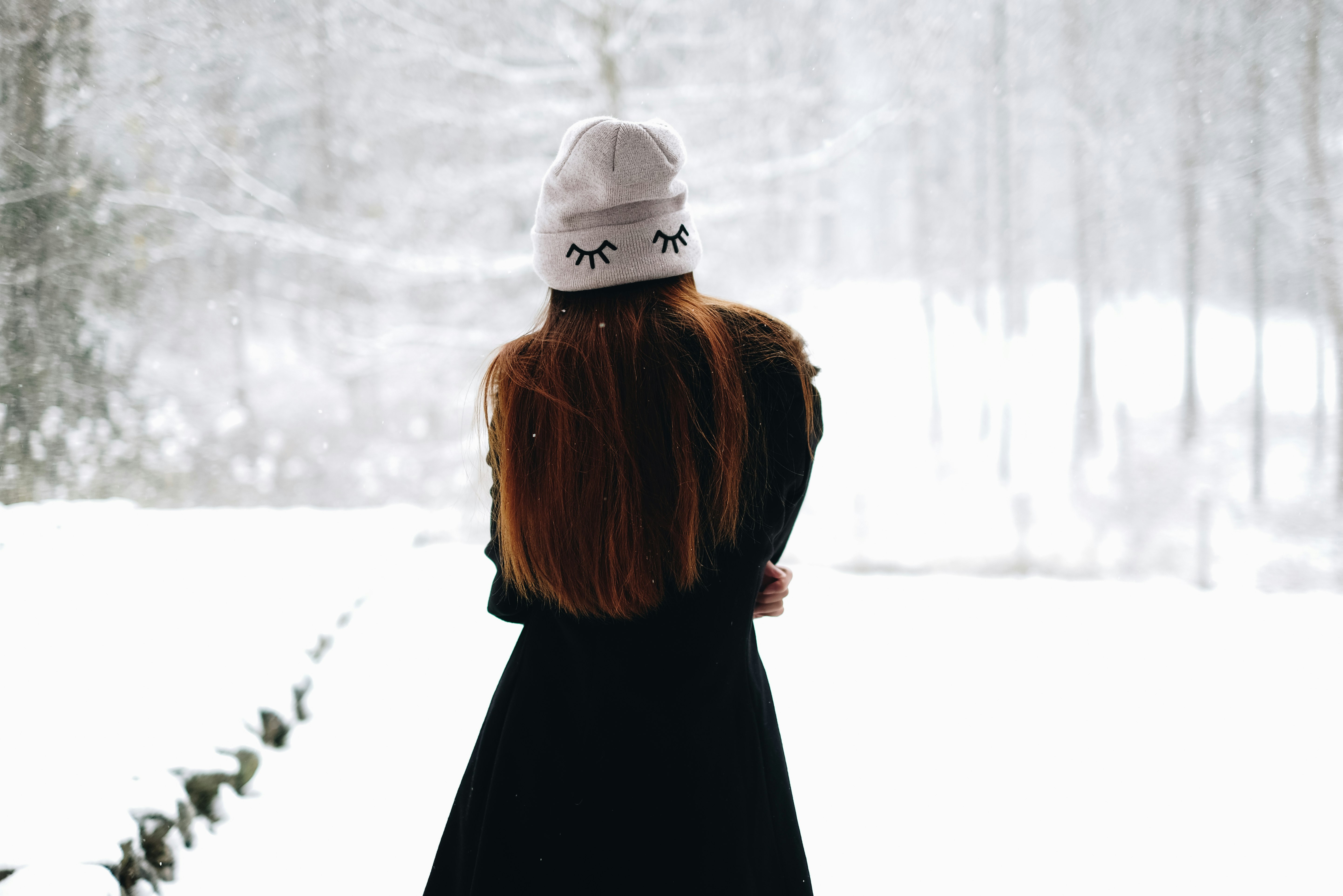 woman standing on white snow-covered field